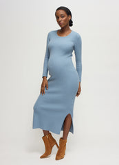 ||A pregnant woman wearing a blue gray long-sleeve ribbed sweater maternity midi dress with tan suede boots