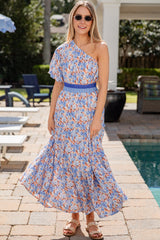 Woman in a floral dress standing by a poolside